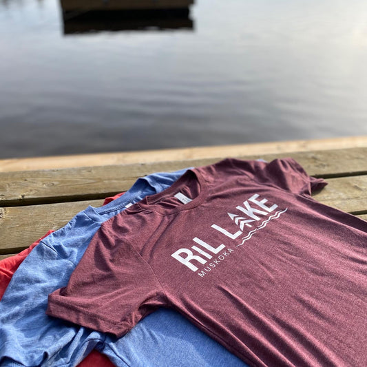 3cotton t-shirts displayed on a dock. T-shirt colours are maroon with white HTV log that reads RIL LAKE MUSKOKA, light blue heather and red heather.
