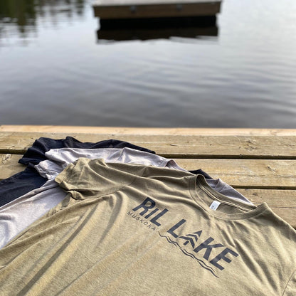 3 cotton t-shirts displayed  laying flat on a dock. Colours are olive with black logo that reads RIL LAKE MUSKOKA, sport grey and black heather.