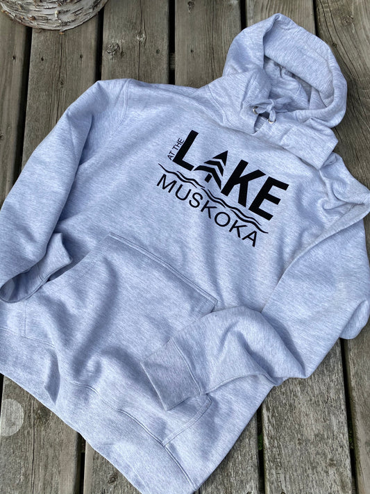 Medium weight hoodie in  light grey heather.  Logo on the front of hoodie reads AT THE LAKE MUSKOKA in black HTV.