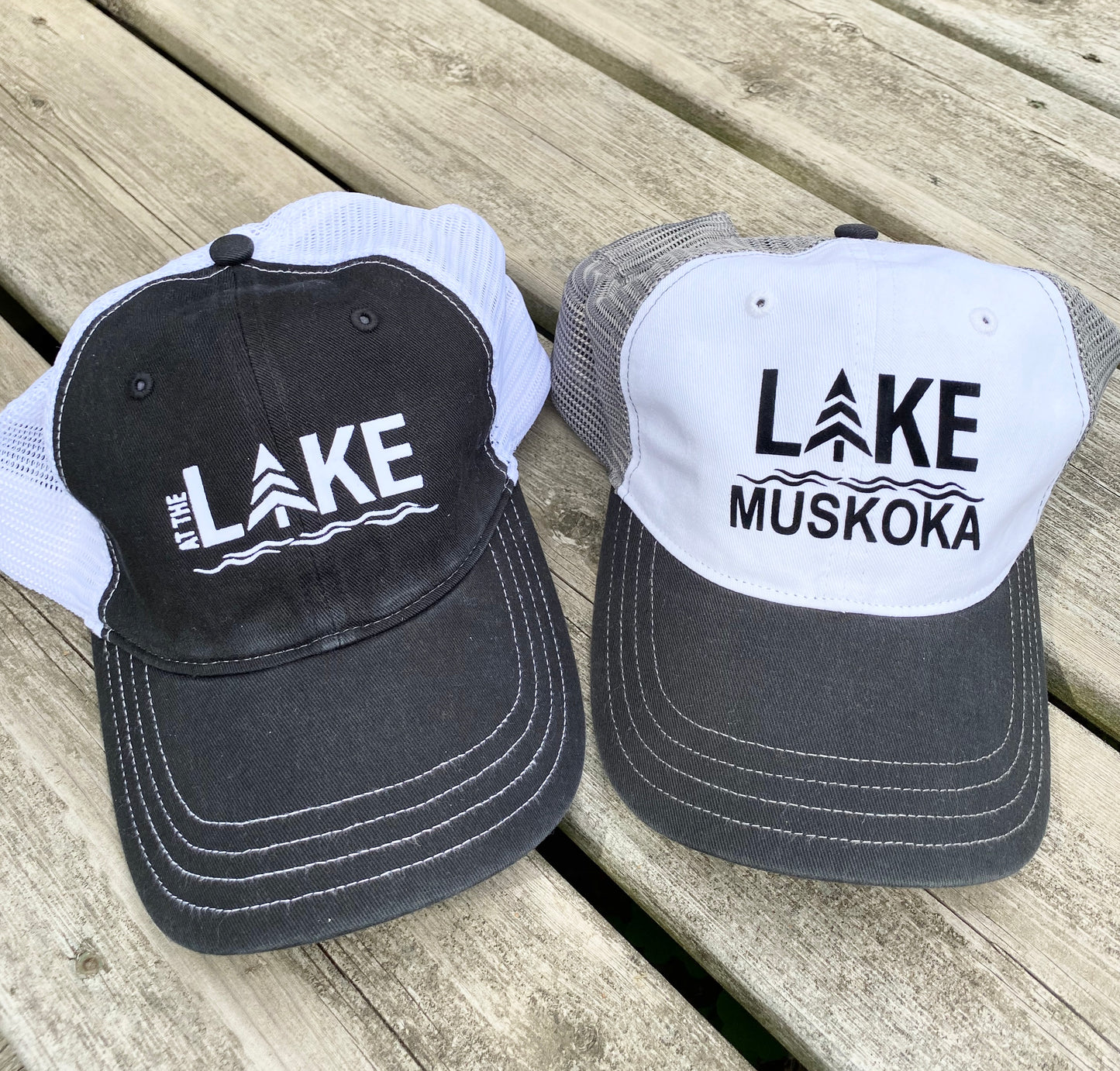 100% cotton front, 100% nylon mesh back Unisex, super-soft, unstructured, low-profile, six panel construction Snapback closure Pre-curved peak. Shown in black with white mesh and HTV logo that reads AT THE LAKE and a black/white with charcoal mesh and HTV logo that reads LAKE MUSKOKA.